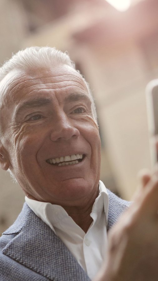 Senior executive smiling on a call